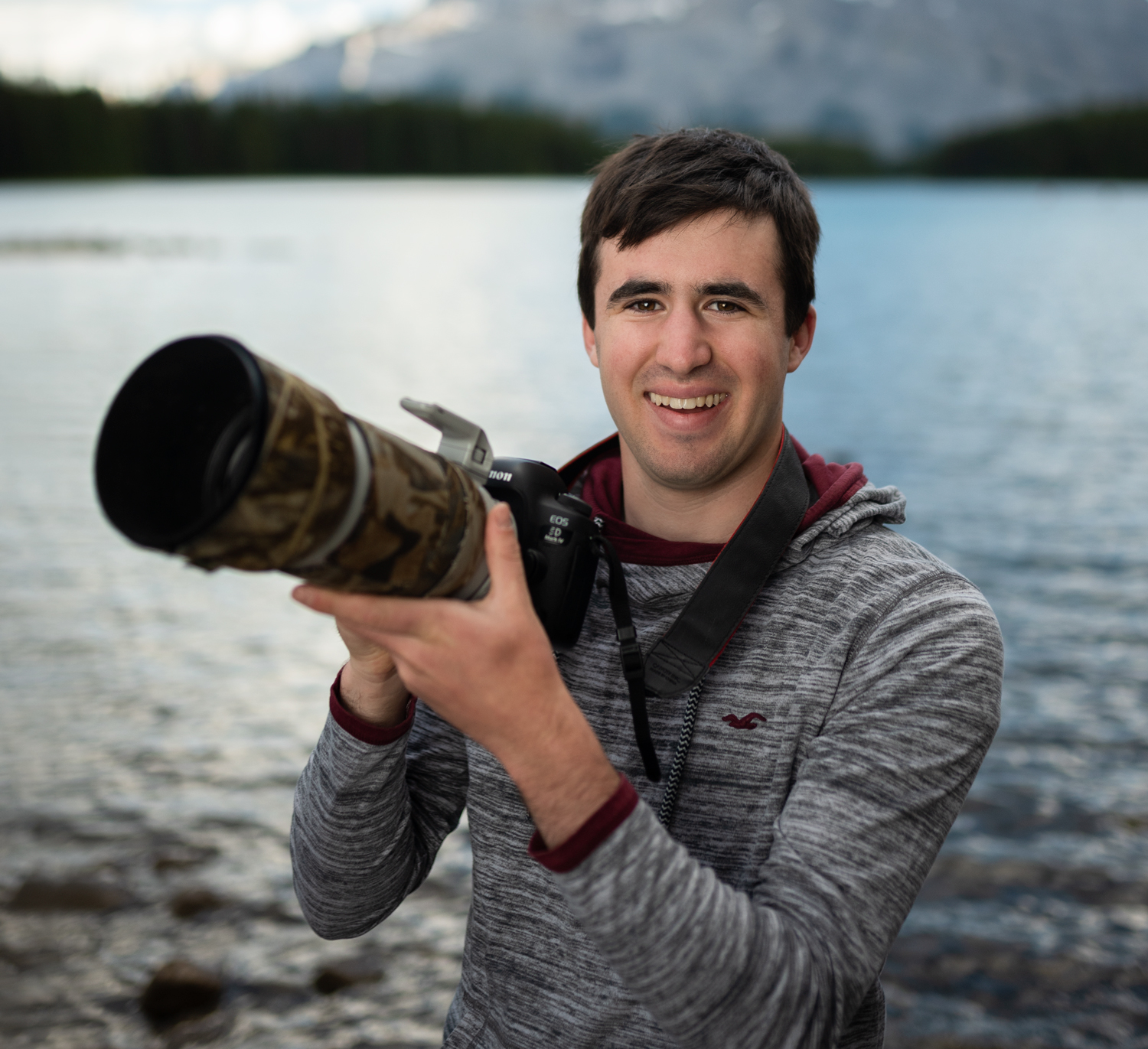 A headshot of Liron Gertsman in the field holding his camera